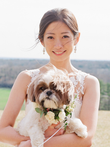 Asian bride in an editorial style wedding picture with her lovely dog.