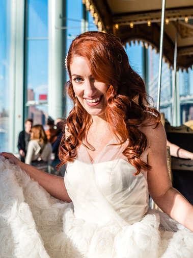 Red hair bride with half up and half down hair style, in Brooklyn carousel. 
