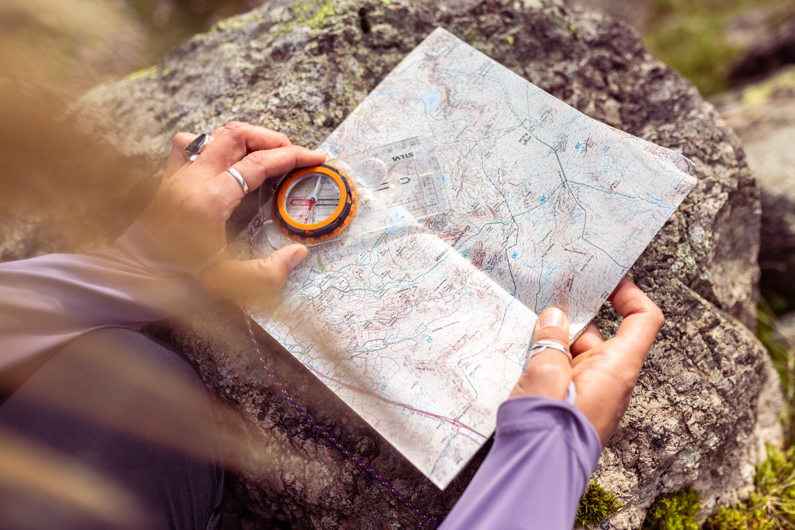 Close up of a map and compass being used 