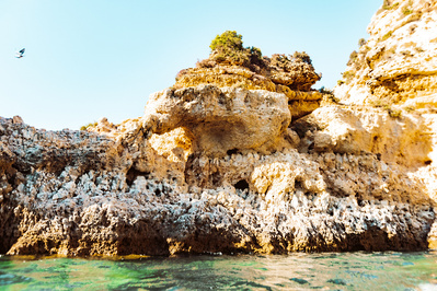 Golden rocks and cliffs from in the water, Portugal