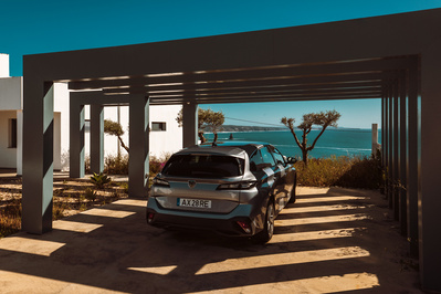Shadows lay over a Peugeot in a modern home garage in Portugal