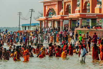 A large group of people bathing in the water in India in a religious ceremony 