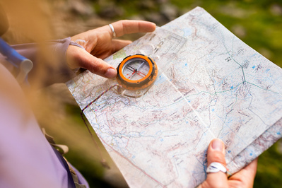 Close up of a map and compass being used 