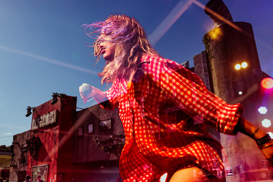 A double exposure of a woman singing at a music festival