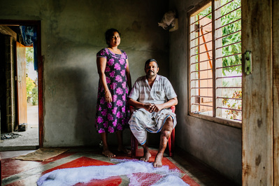 A couple pose for a portrait in a traditional way