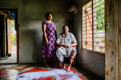 A couple pose for a portrait in a traditional way