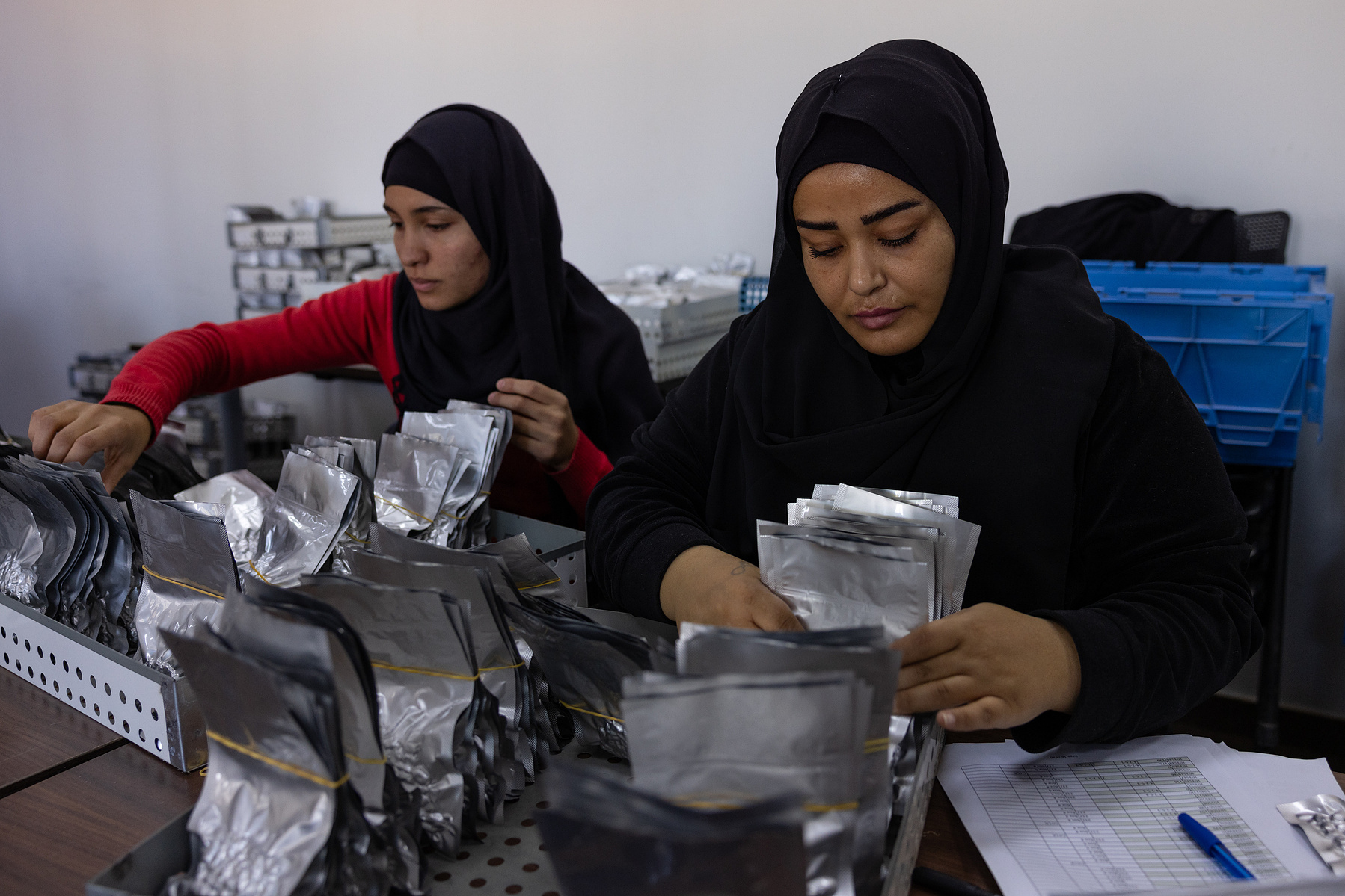 Fatima Hamid (right) and Amina Itani (left) sort seeds to send to a sister gene bank in Morocco.
