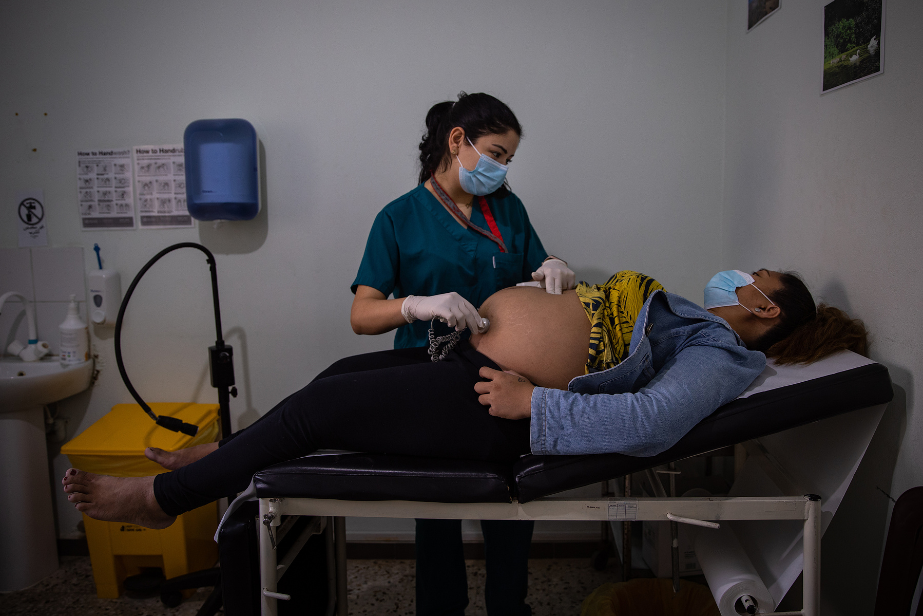 Arlene, 28, listens to her baby's heartbeat during a pre-natal checkup. She is 9 months and two days pregnant and this is her second preganancy. Arlene's first child was delivered naturally, and she hopes that the second birth is done via vaginal deliver