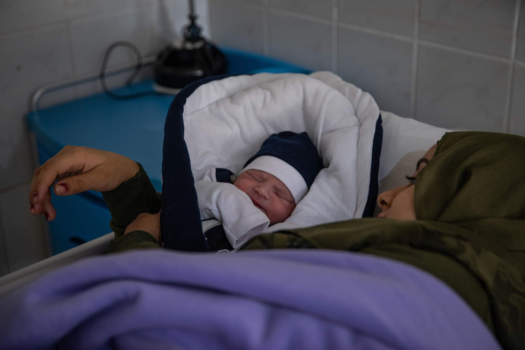 Sultana (18) holds her healthy baby boy Adam, a few hours after giving birth naturally at the Médecins Sans Frontières (MSF) Birth Center at Rafik Hariri University Hospital (RHUH).