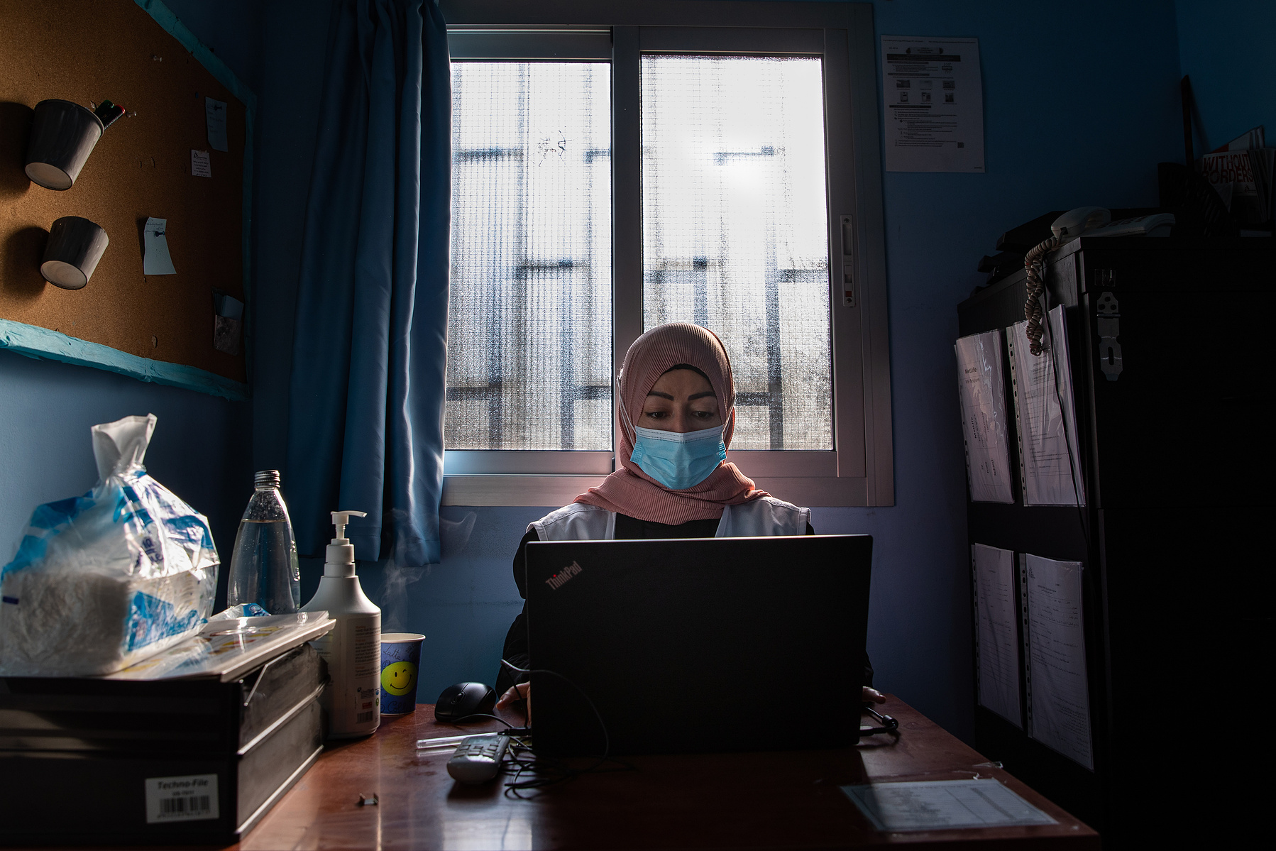 Mariam Ali, Health Promoter (HP) sits at her desk in MSF's clinic in Burj Al Barajneh. As an HP Mariam gives presentations about public health topics and talks through family planning options with women in the refugee camp.