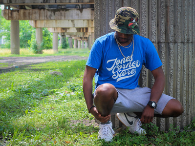 Dion Turner, a Chicago-based photographer, steps in front of the camera to model for *Jones Corner Store*, a local clothing brand that celebrates community and streetwear culture.