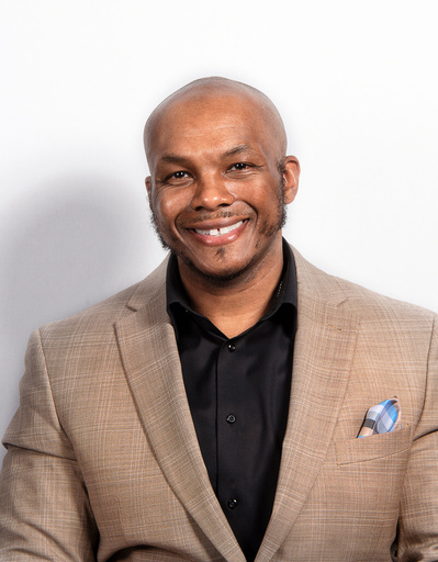 Business headshot photo showing a male professional