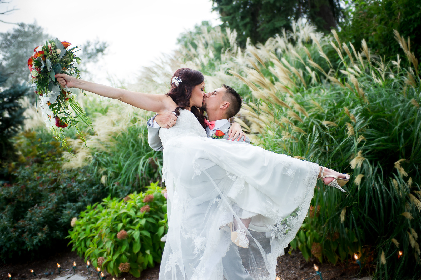 Bride being lifted by Groom on wedding day
