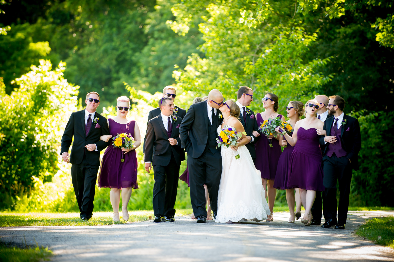 Couple with bridal party walking in the park
