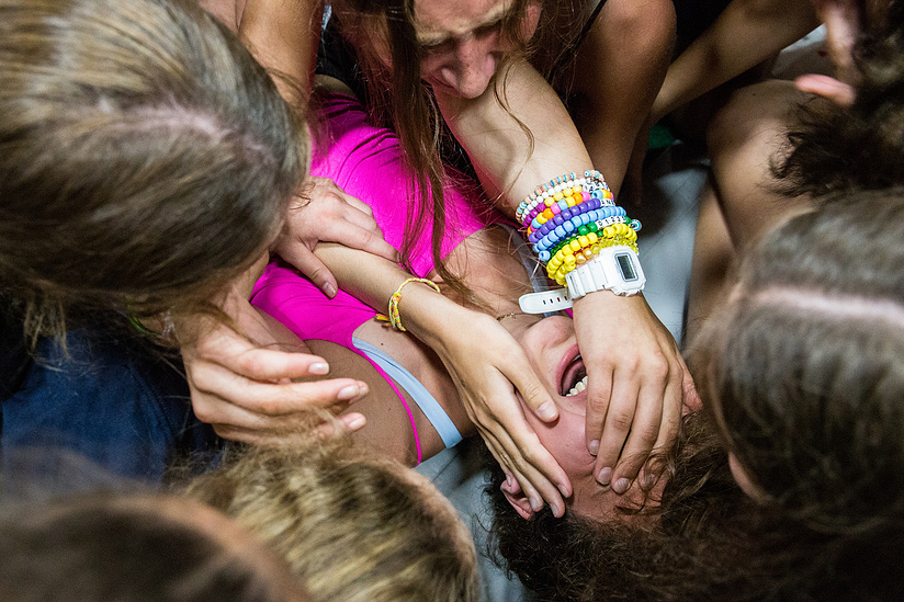Annex campers pile onto the newest Camp Olympics co-captain during the Breakout ceremony on July 30, 2019, in the Gymnastics Pavilion at Camp Romaca.
