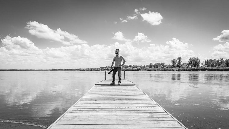 Photographer Thomas Hatzenbuhler on a dock along the Missouri River