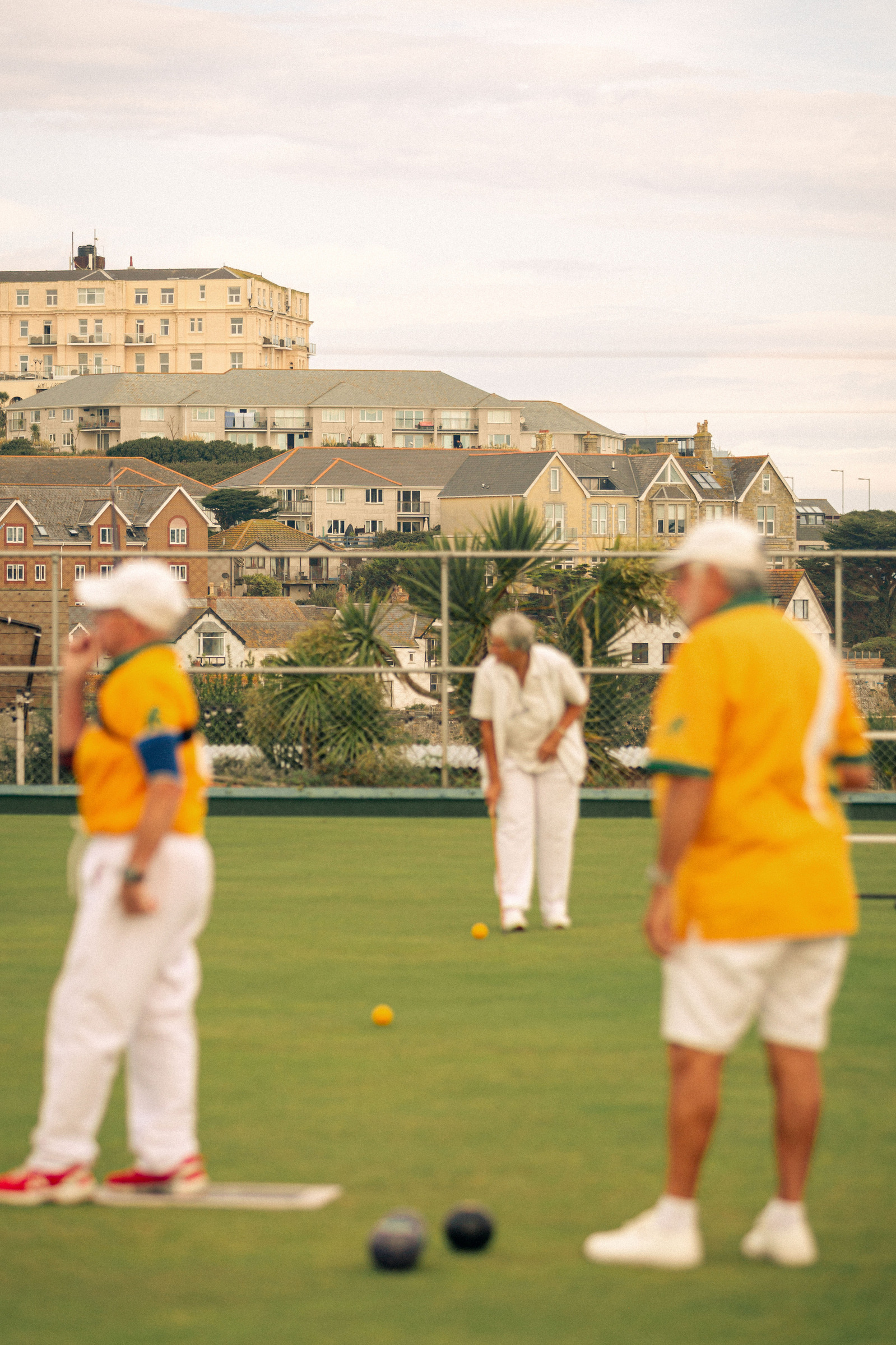 Newquay West End Bowls Club playing at their location above the Newquay harbour, in Cornwall, Western England.