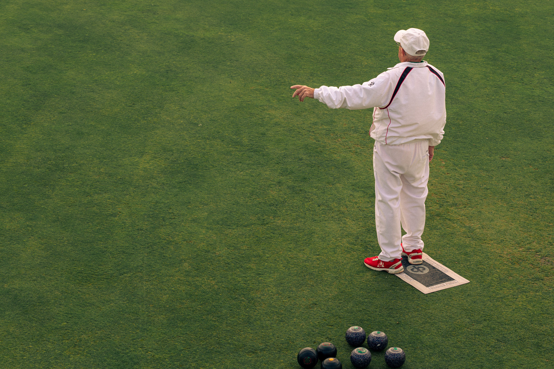 Newquay West End Bowls Club playing at their location above the Newquay harbour, in Cornwall, Western England.