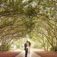 Bride's radiant smile lights up the enchanting pathways of Dallas Arboretum.