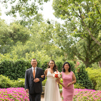 Bride and groom share a tender moment amidst the lush gardens of Dallas Arboretum.