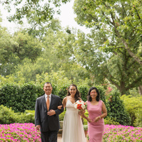 Bride and groom share a tender moment amidst the lush gardens of Dallas Arboretum.