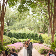 Joyous bridal party celebrates amidst the vibrant colors of Dallas Arboretum's botanical wonders.