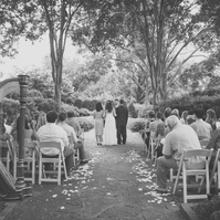 Romantic wedding ceremony captured under the canopy of blooming flowers at Dallas Arboretum.