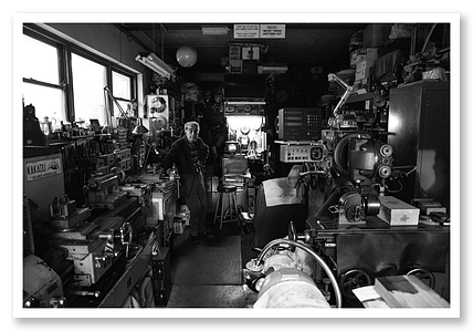 Old man, showing his tools and his life work. Showing all different types of cameras, machinery and clocks.