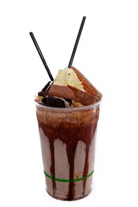 Milk shake with a  white background with cream and ice cream spilling out.