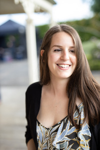 Model smiling for a photograph at a wedding.