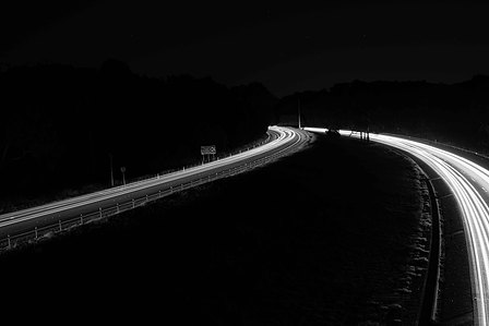 black and white photo of long exposure photo of the free way and light trails.