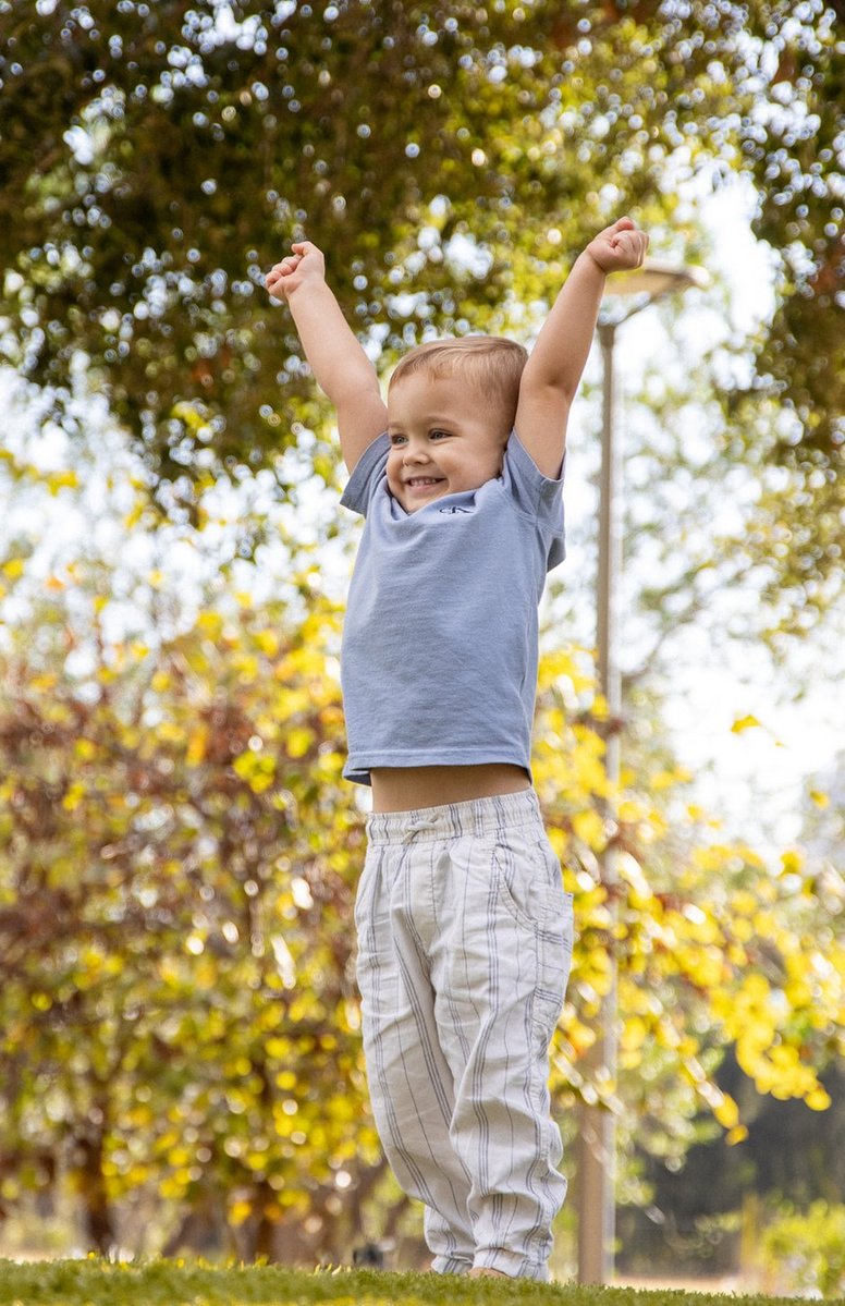 Little one celebrating with raised hands