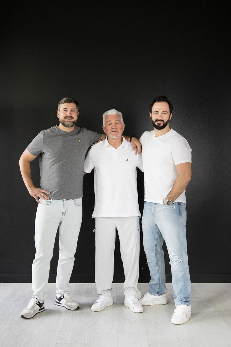 Father and sons — clean studio portrait