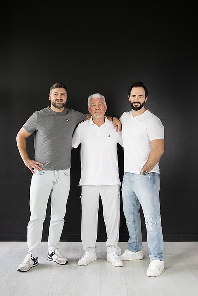 Father and sons — clean studio portrait