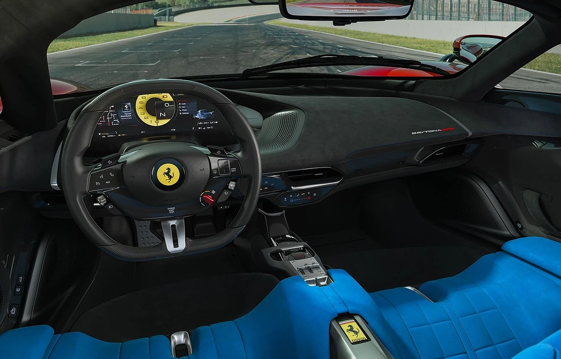 PASSIVE AERO EFFICIENCY WITH RACING CAR PERFORMANCE OF FERRARI DAYTONA SP3 ON A RACE TRACK WITH BLUE SEATS AND A BLACK DASHBOARD