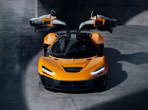 McLaren W1 supercar in a sleek urban setting. enquire with west2east luxury
