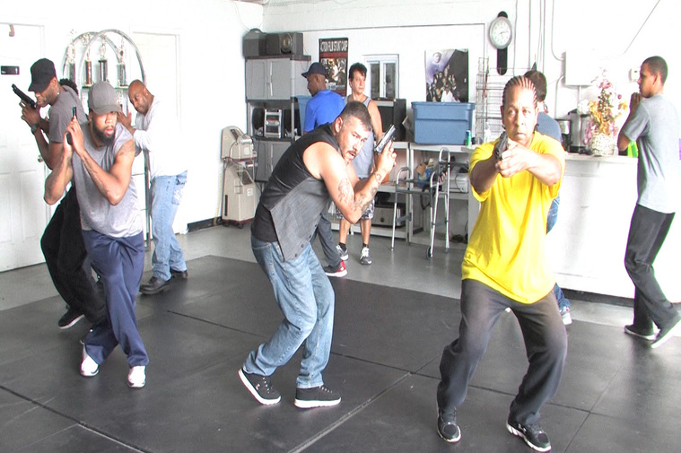 Director Tom Henry teaching weapons training for one of his films