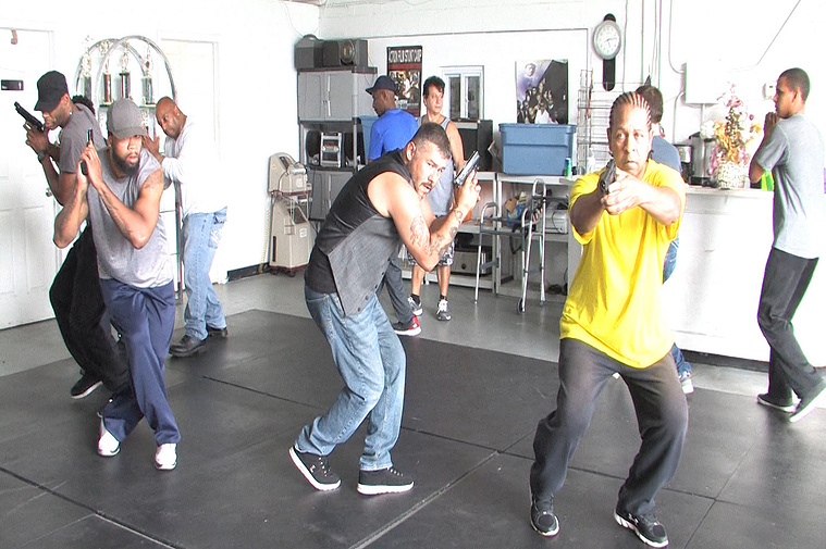 Director Tom Henry teaching weapons training for one of his films