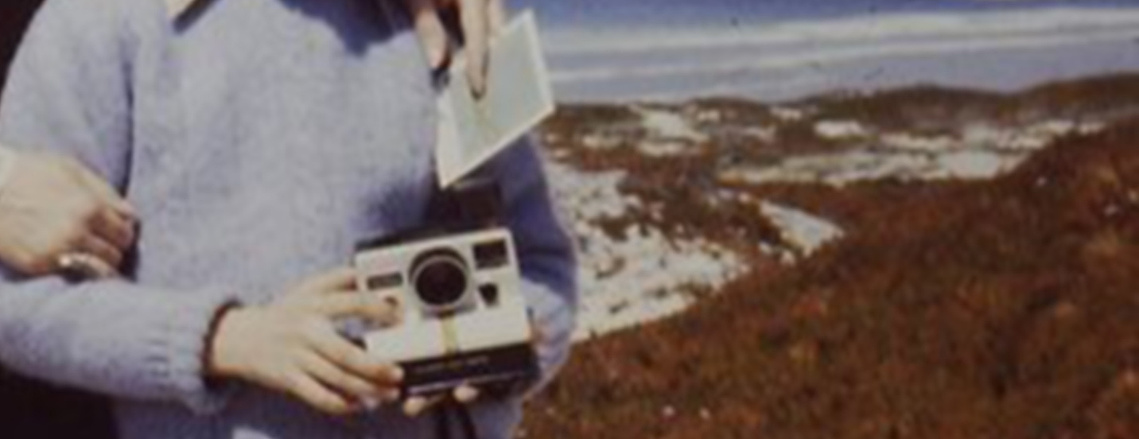 Young photographer with first Polaroid camera.