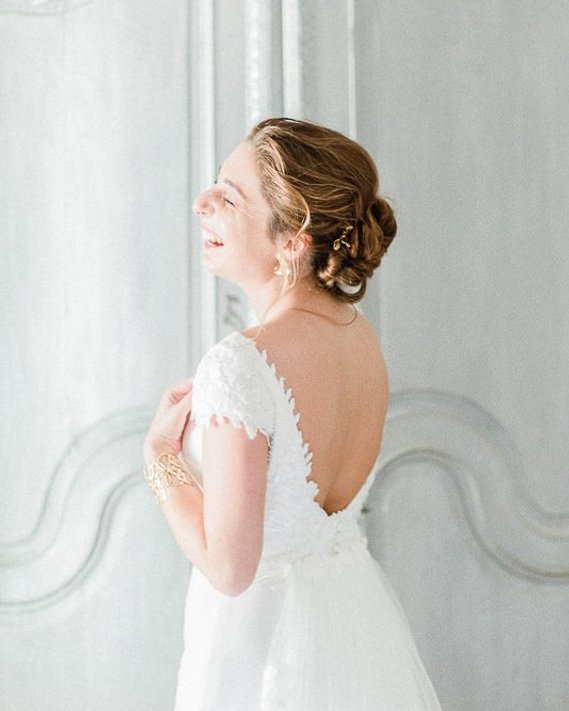 Fine Art Bride laughing during her preparation before the wedding ceremony