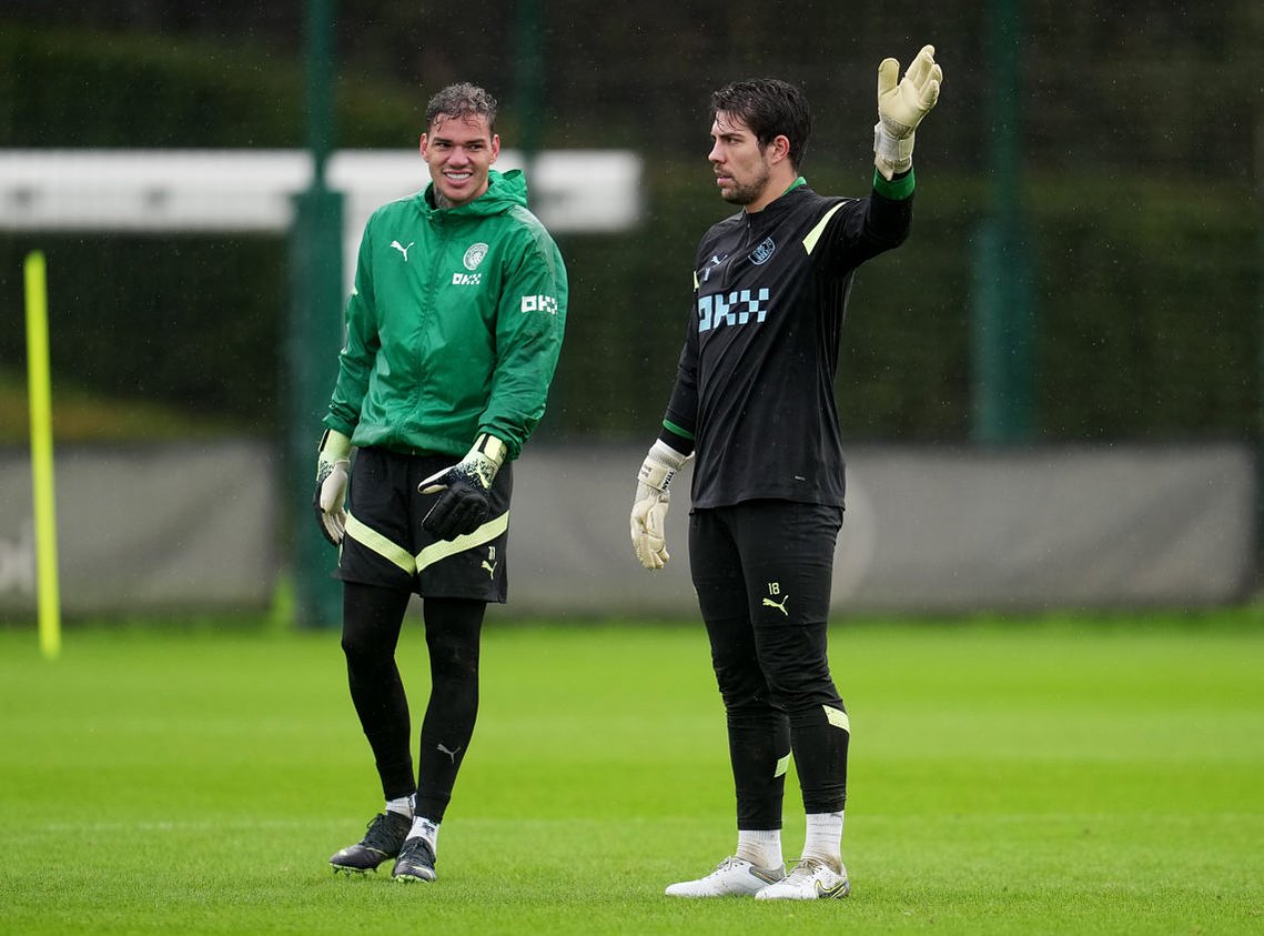Ederson and Ortega share a smile during a training session. 