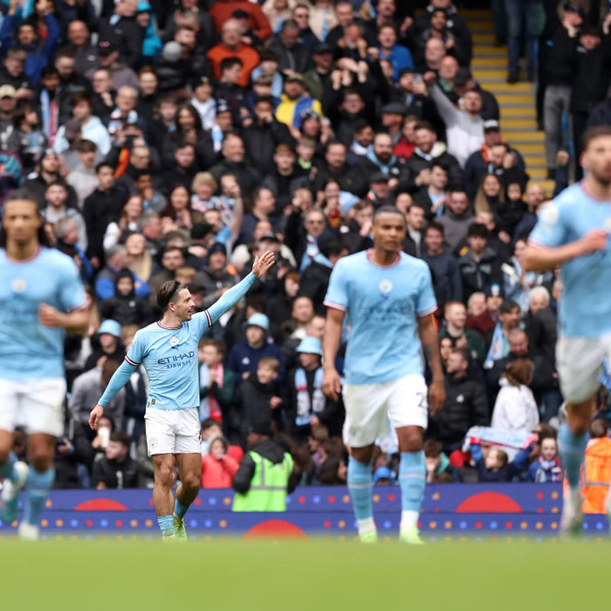Jack Grealish waves to Manchester City supporters as they chant his name against Liverpool. 