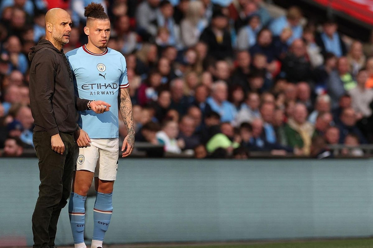 Kalvin Phillips takes orders from manager Pep Guardiola in a rare substitute appearance. 