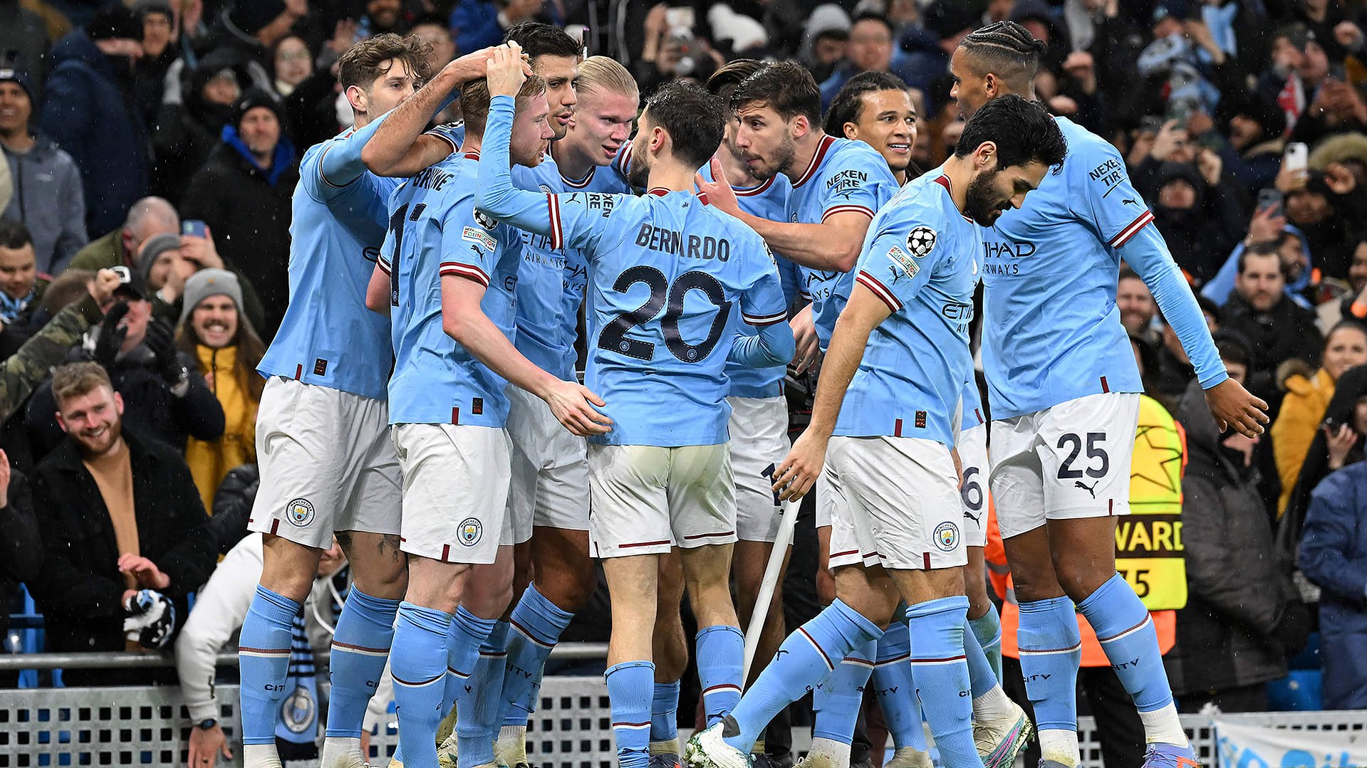 Manchester City players celebrate scoring a goal. 