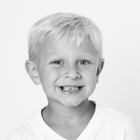 sweet blonde boy with the perfect toothless smile in black and white