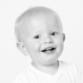 baby boy clapping hands and laughing in black and white