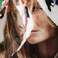 A shredded double portrait of a young white woman with long blond hair looking sad. Her duplicate image is hanging losing over the same image providing a "split personality" or schizophrenic meaning to this photo. Woeful. Forlorn. Sad. Shattered