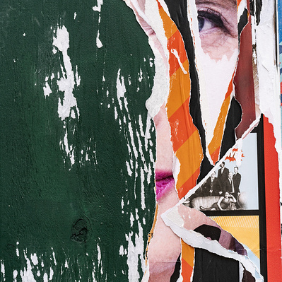 A shredded poster image, only a partial eye and a corner of the mouth are visible, identifiable as Isabella Rossellini, behind masked colorful orange striped later posters, and a black and white family photo inset against a green wooden barrier.