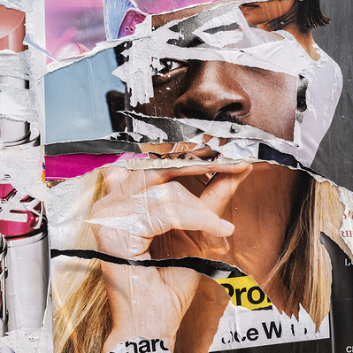 A layered series of torn advertising posters on an urban construction wall create a sculptural effect, a totem of mixed races and genders and scales. The center is a Black male and a White woman's hand. One eye, one nose, two heads. "Get the Look"