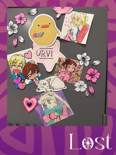 Gallery Image: Text reads: LOST. On a purple border around an image of a sticker covered surface. The central sticker is a star that reads: URVI. Other stickers include flowers, hearts, Anime drawings and a duck holding a knife.